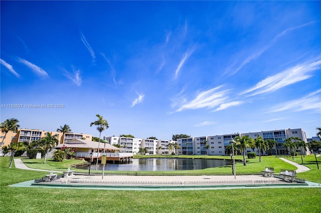 surrounding community with a lawn and a water view