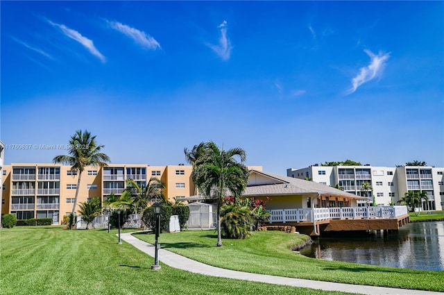 view of property's community featuring a yard and a water view