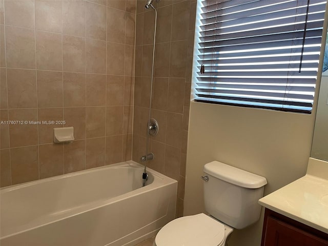 bathroom with shower / bathtub combination, toilet, and vanity