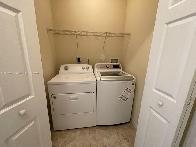 clothes washing area with washing machine and dryer