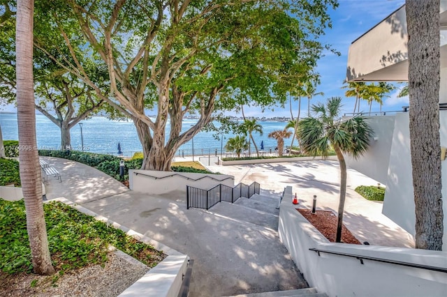 surrounding community featuring fence and a water view