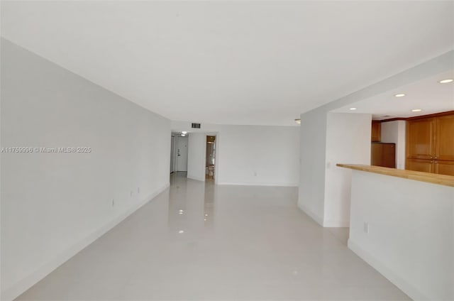 empty room featuring recessed lighting, visible vents, and concrete flooring