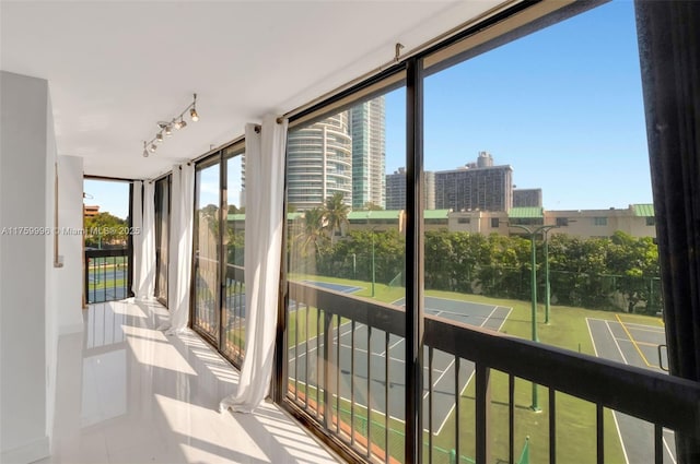 sunroom with a city view and rail lighting