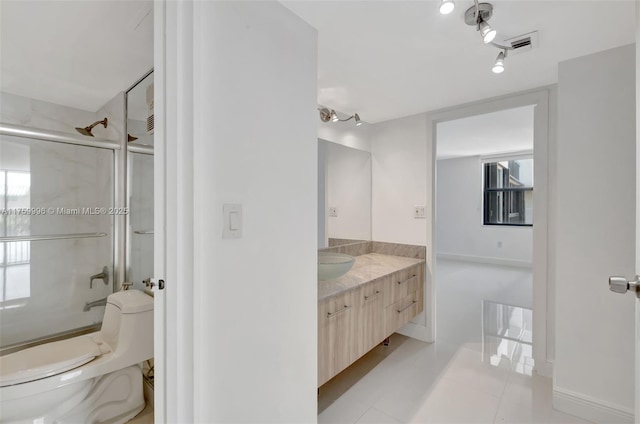 bathroom with vanity, visible vents, enclosed tub / shower combo, tile patterned floors, and toilet