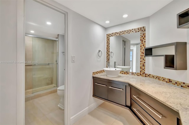 bathroom with tile patterned floors, tasteful backsplash, a stall shower, and recessed lighting