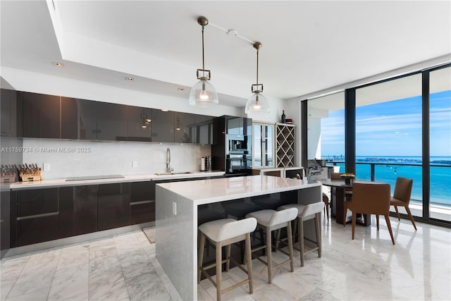 1451 Brickell Ave Unit 4002, Miami, FL 33131 - kitchen featuring a sink, oven, modern cabinets, decorative backsplash, and a wall of windows
