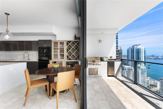 dining room featuring a view of city and marble finish floor