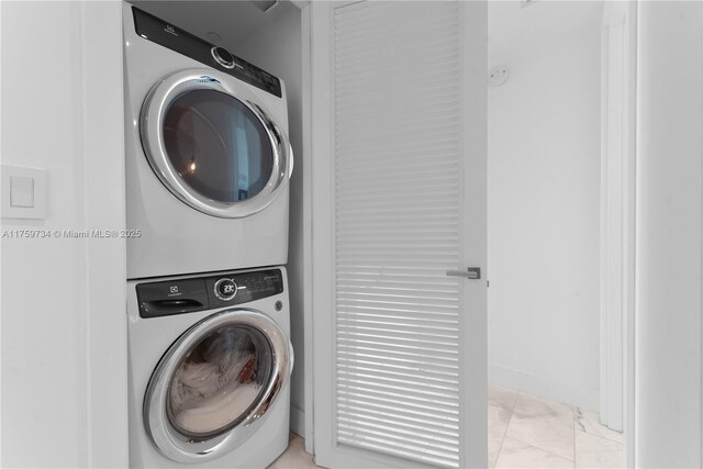 1451 Brickell Ave Unit 4002, Miami, FL 33131 - washroom with stacked washer / dryer and light marble finish floors