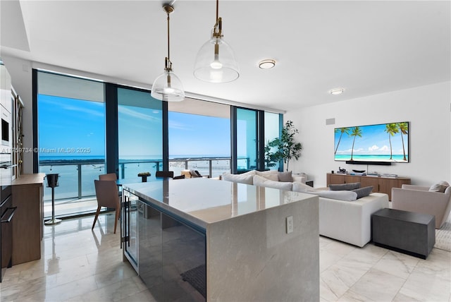 1451 Brickell Ave Unit 4002, Miami, FL 33131 - kitchen with expansive windows, pendant lighting, light marble finish flooring, a center island, and open floor plan