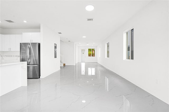 interior space featuring recessed lighting, visible vents, and marble finish floor