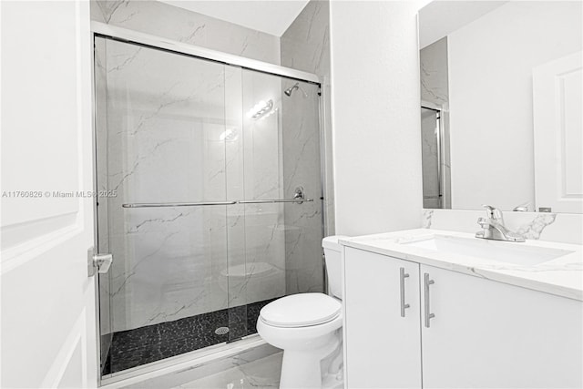 full bathroom with a marble finish shower, toilet, marble finish floor, and vanity