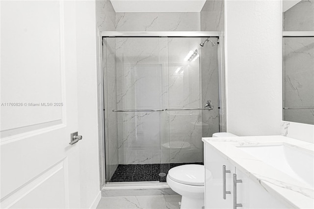 full bathroom featuring vanity, toilet, marble finish floor, and a marble finish shower