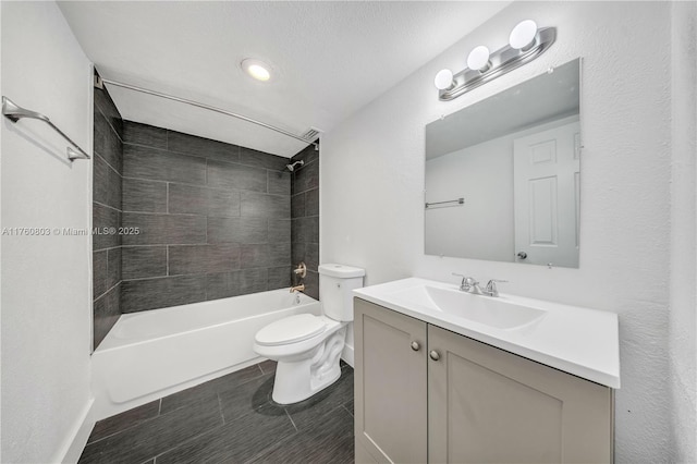 bathroom with toilet, vanity, and shower / tub combination