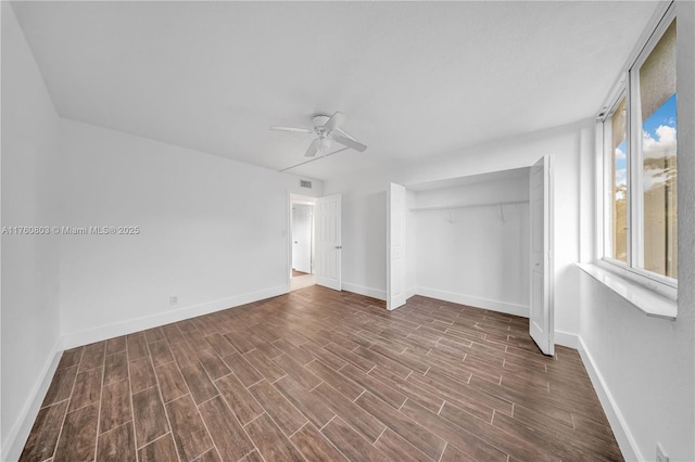 unfurnished bedroom featuring wood finished floors, baseboards, a closet, and ceiling fan