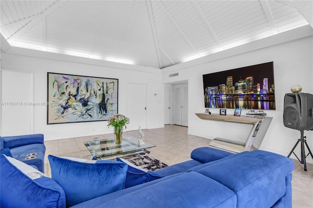 living area featuring baseboards, visible vents, high vaulted ceiling, tile patterned flooring, and beamed ceiling