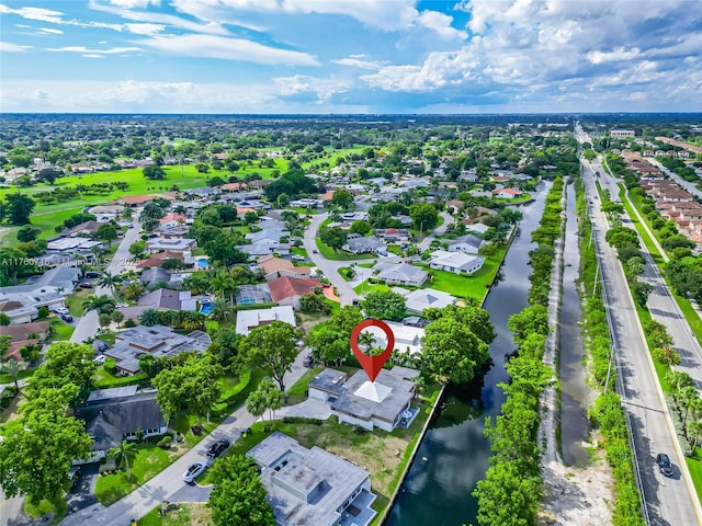 drone / aerial view with a residential view and a water view