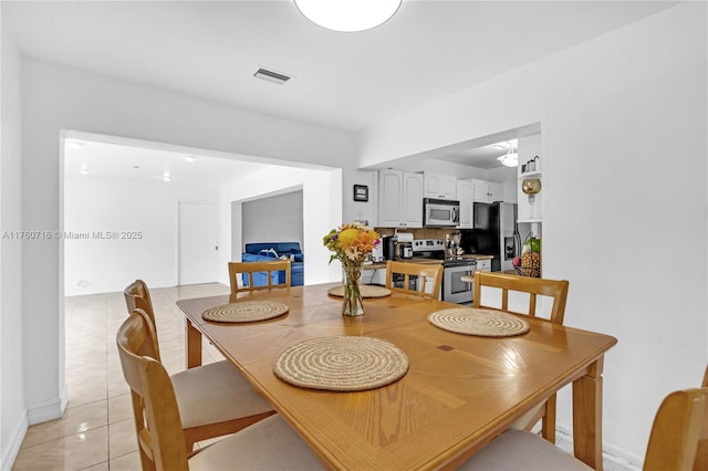 dining area featuring light tile patterned flooring and visible vents