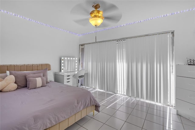 tiled bedroom with a ceiling fan