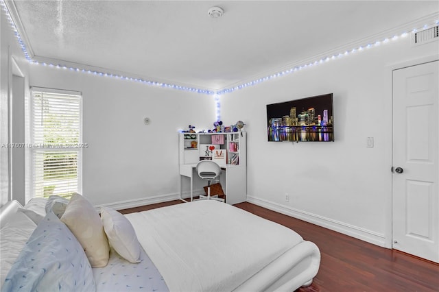 bedroom with baseboards, visible vents, and dark wood-style flooring