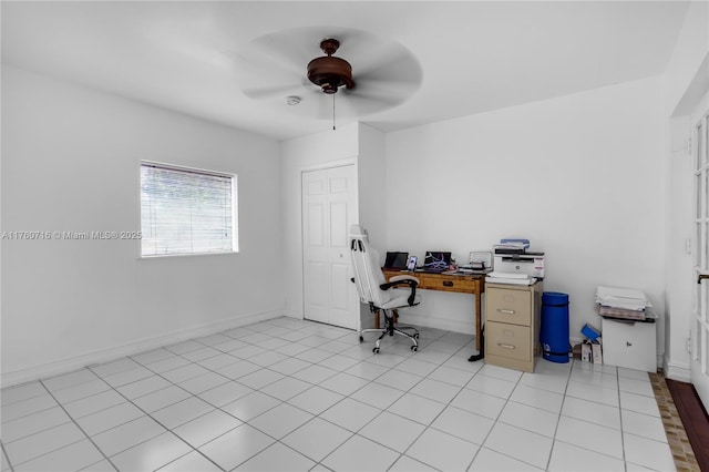 office space featuring light tile patterned flooring, baseboards, and ceiling fan