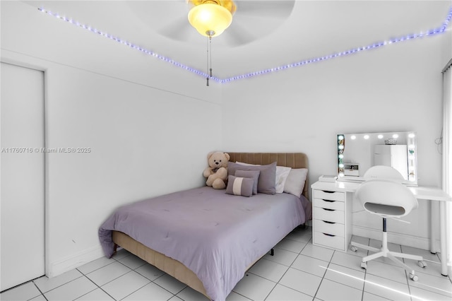 bedroom with baseboards, a ceiling fan, and light tile patterned floors