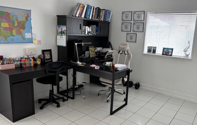 home office with light tile patterned flooring and baseboards