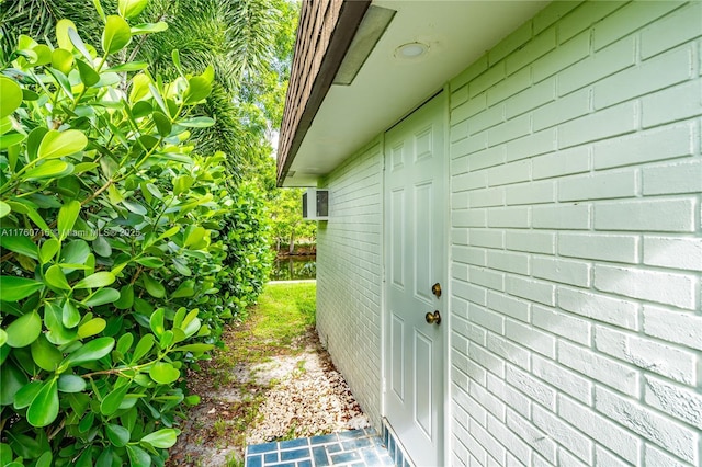 entrance to property featuring concrete block siding