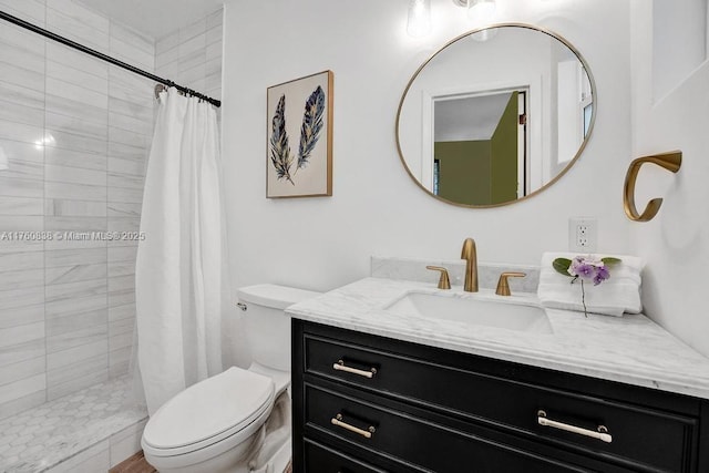 full bath with a tile shower, toilet, and vanity