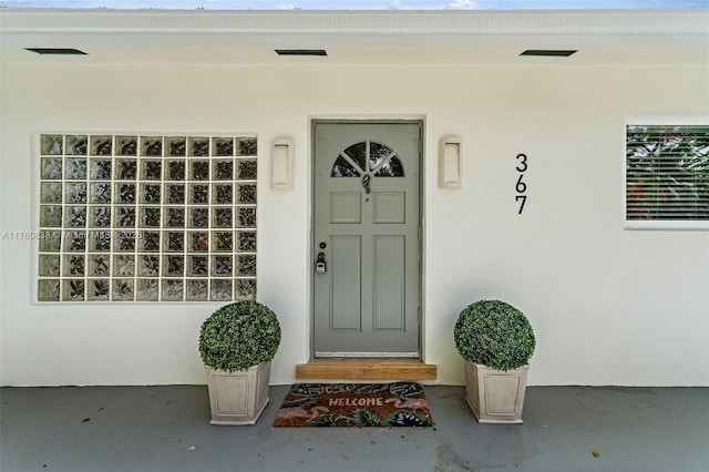 367 W Riverside Dr, Tequesta, FL 33469 - view of exterior entry with stucco siding