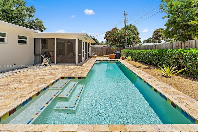 367 W Riverside Dr, Tequesta, FL 33469 - view of swimming pool featuring a sunroom, a fenced backyard, a patio area, and ceiling fan