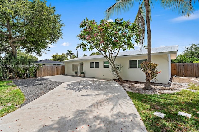 367 W Riverside Dr, Tequesta, FL 33469 - ranch-style home with stucco siding and a patio area