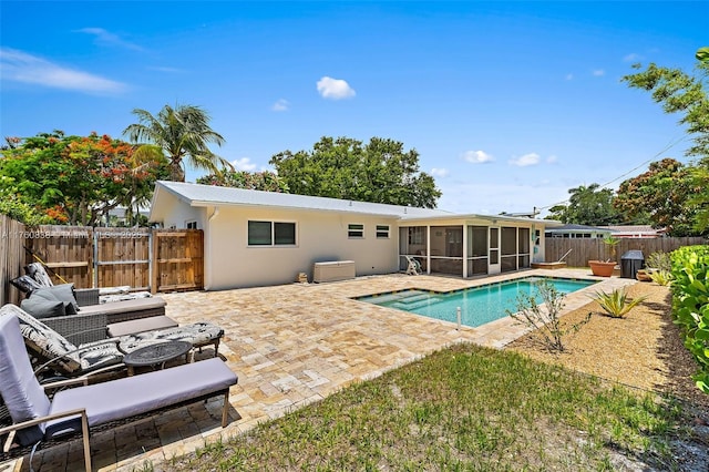 367 W Riverside Dr, Tequesta, FL 33469 - view of pool with a sunroom, a patio area, and a fenced backyard
