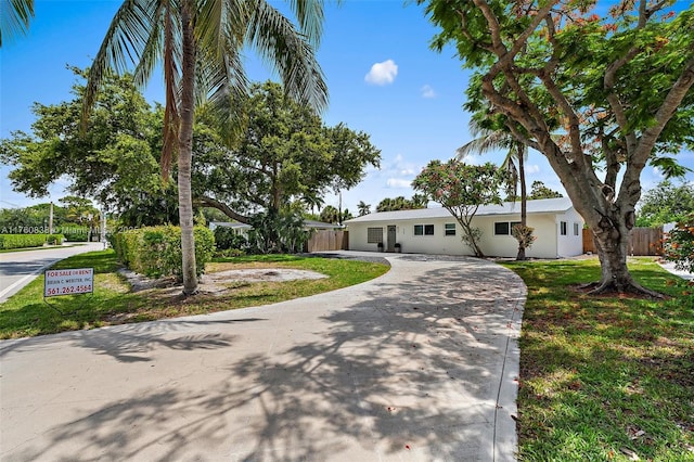 367 W Riverside Dr, Tequesta, FL 33469 - ranch-style house featuring stucco siding and driveway