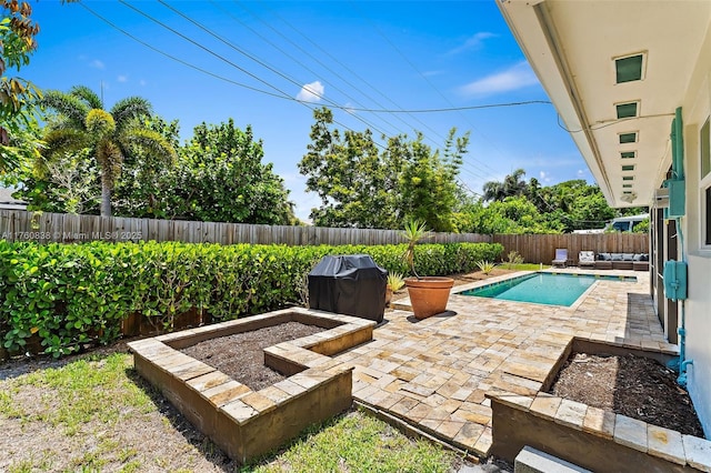 367 W Riverside Dr, Tequesta, FL 33469 - view of swimming pool featuring a grill, a patio area, and a fenced backyard
