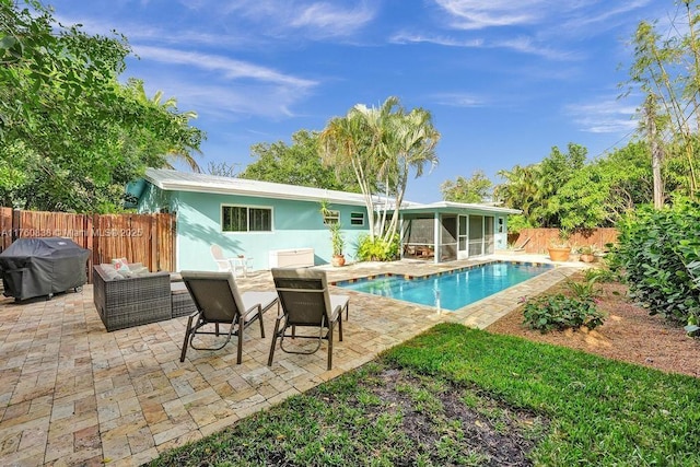 rear view of property featuring an outdoor living space, a patio, a fenced backyard, a sunroom, and a fenced in pool