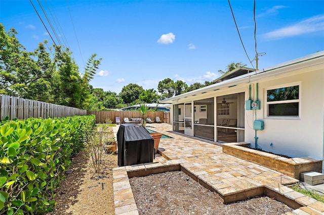 367 W Riverside Dr, Tequesta, FL 33469 - fenced backyard with a sunroom and a patio