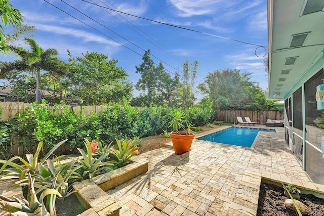 view of swimming pool featuring a patio, a fenced backyard, and a fenced in pool