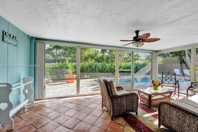 sunroom featuring a ceiling fan