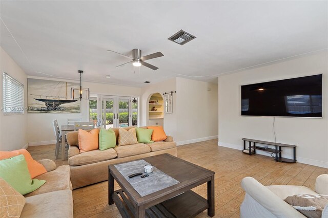 367 W Riverside Dr, Tequesta, FL 33469 - living room featuring light wood-type flooring, plenty of natural light, french doors, and a ceiling fan