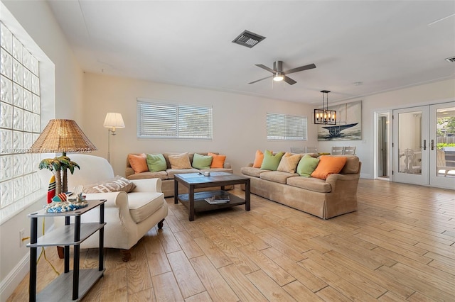 367 W Riverside Dr, Tequesta, FL 33469 - living room with light wood-style floors, a ceiling fan, french doors, and a chandelier