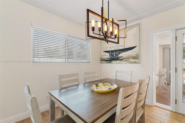 367 W Riverside Dr, Tequesta, FL 33469 - dining room featuring a chandelier and light wood-type flooring