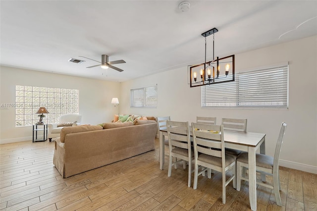367 W Riverside Dr, Tequesta, FL 33469 - dining space with light wood-type flooring, ceiling fan, and a chandelier