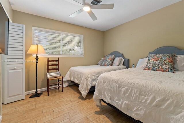 367 W Riverside Dr, Tequesta, FL 33469 - bedroom with light wood-style floors and a ceiling fan