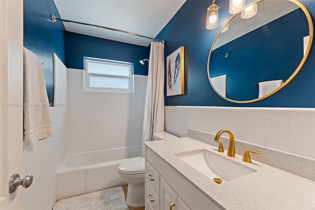 367 W Riverside Dr, Tequesta, FL 33469 - bathroom featuring tile walls, shower / tub combo with curtain, vanity, and wainscoting