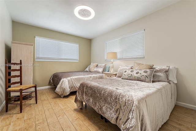 367 W Riverside Dr, Tequesta, FL 33469 - bedroom featuring baseboards and light wood-style flooring