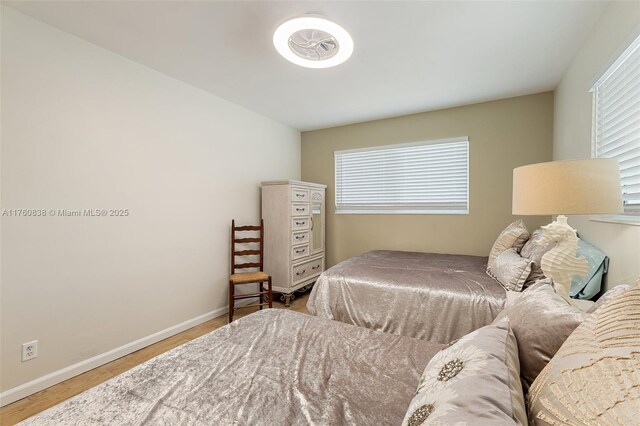 367 W Riverside Dr, Tequesta, FL 33469 - bedroom with wood finished floors and multiple windows