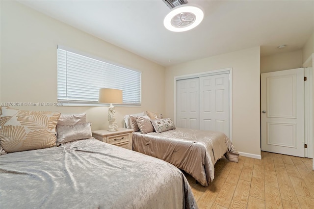 367 W Riverside Dr, Tequesta, FL 33469 - bedroom featuring light wood finished floors and a closet