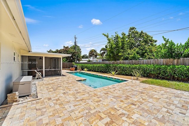 367 W Riverside Dr, Tequesta, FL 33469 - view of swimming pool with a sunroom, a patio, and a fenced backyard