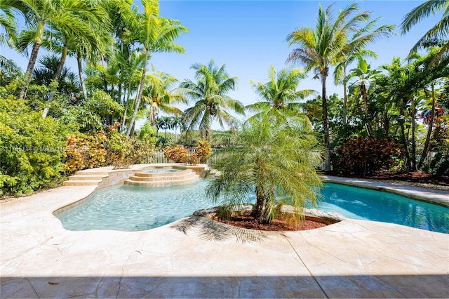 view of swimming pool with a pool with connected hot tub and a patio