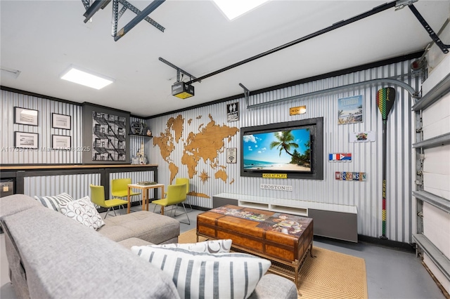 home theater featuring a garage and finished concrete floors